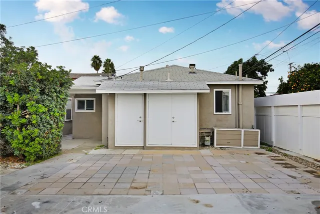 a view of a house with a patio and a yard