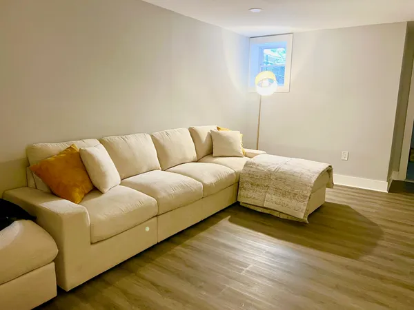 a living room with a couch and a wooden floor