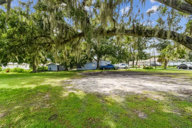 a view of outdoor space with playground and green space
