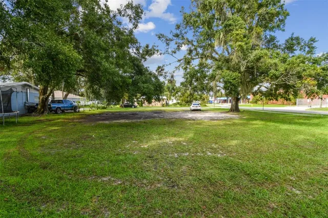 a view of a field with trees in the background