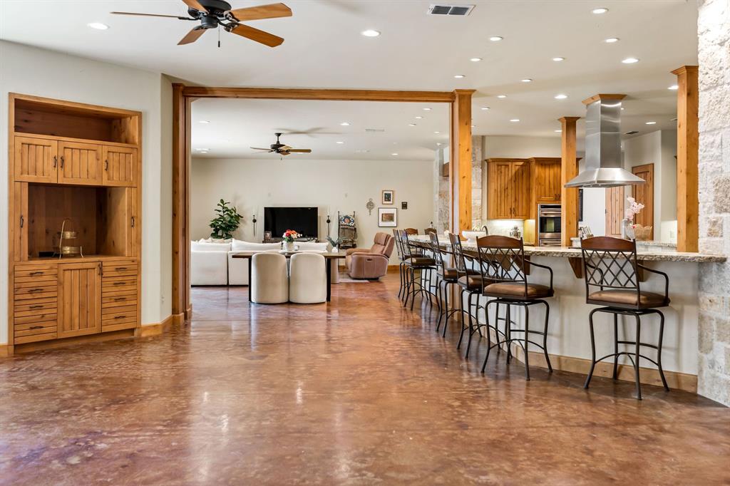 9930 Boat Club Road Fort Worth, TX 76179 - Photo 33 of 40 Hill Lodge features two spacious living areas that flow seamlessly into a large, open kitchen and bar seating.