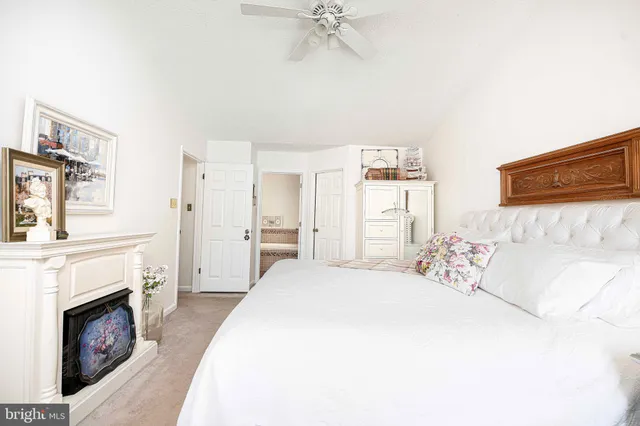 a spacious bedroom with a bed and a fireplace