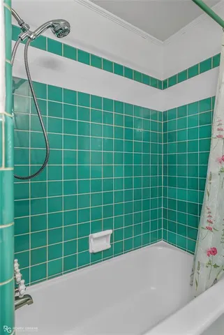 a view of a bathroom with a bathtub and window