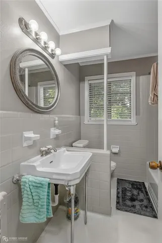 a bathroom with a sink a mirror and a window