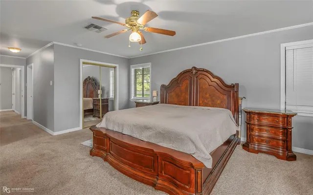 a spacious bedroom with a bed and a chandelier