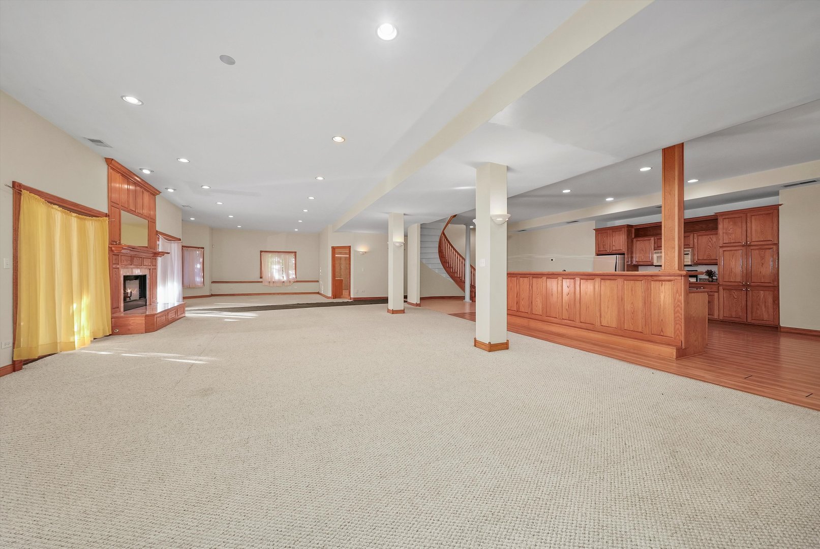 13220 Fox Lane Lemont, IL 60439 - Photo 26 of 43 a view of a big room with staircase and a kitchen view