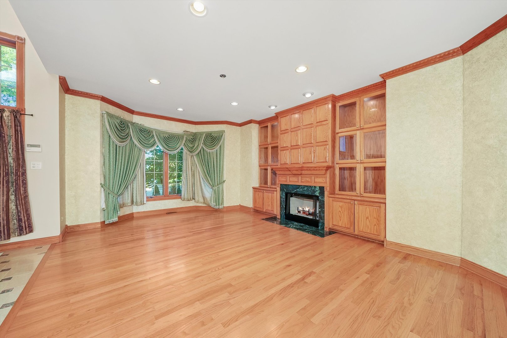 13220 Fox Lane Lemont, IL 60439 - Photo 7 of 43 a view of an empty room with a fireplace and a window