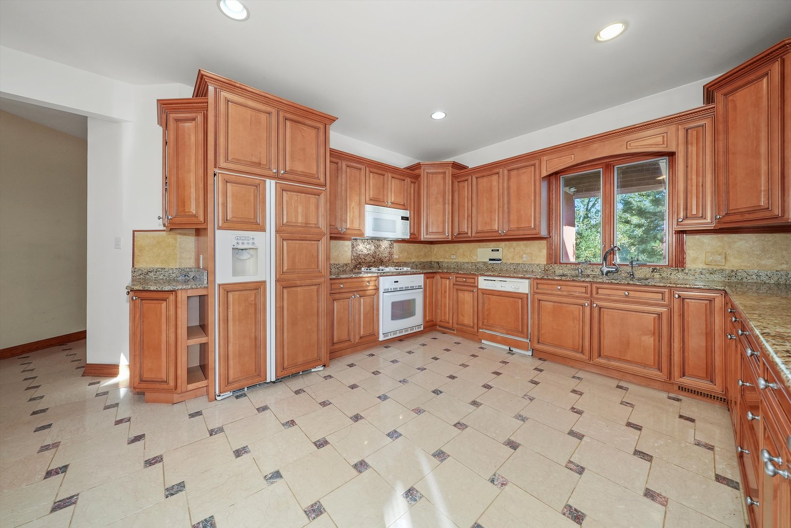 13220 Fox Lane Lemont, IL 60439 - Photo 8 of 43 a kitchen with stainless steel appliances a sink a stove a refrigerator cabinets and a window