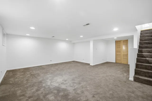 an empty room with a fireplace and lots of windows