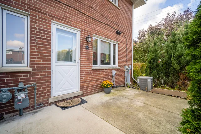 a view of a brick house with many windows