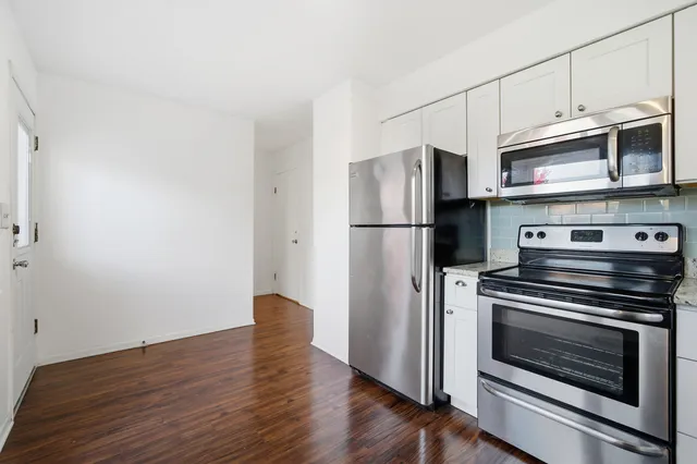 a kitchen with stainless steel appliances a refrigerator stove and microwave