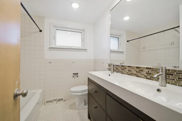 a bathroom with a sink a toilet and mirror