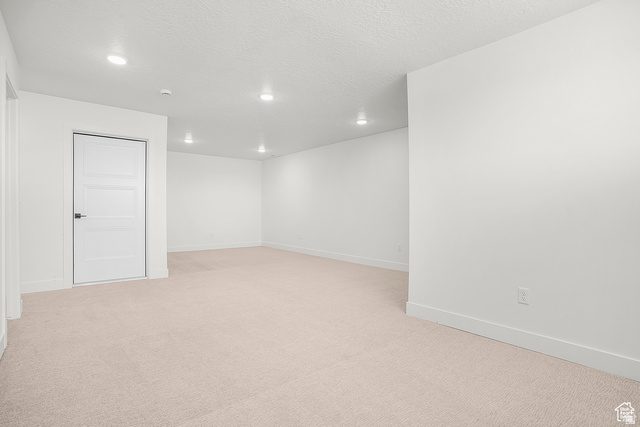 1631 West Century Lane, Unit C Mapleton, UT 84664 - Photo 24 of 31 Spacious room featuring neutral carpeting, white walls, recessed lighting, and a modern paneled door with black hardware