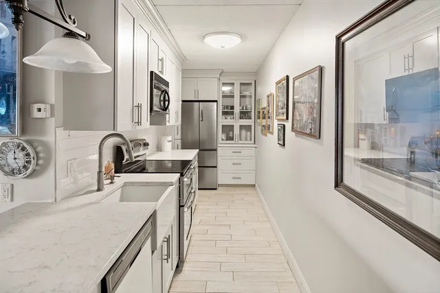a kitchen with stainless steel appliances a sink and a refrigerator