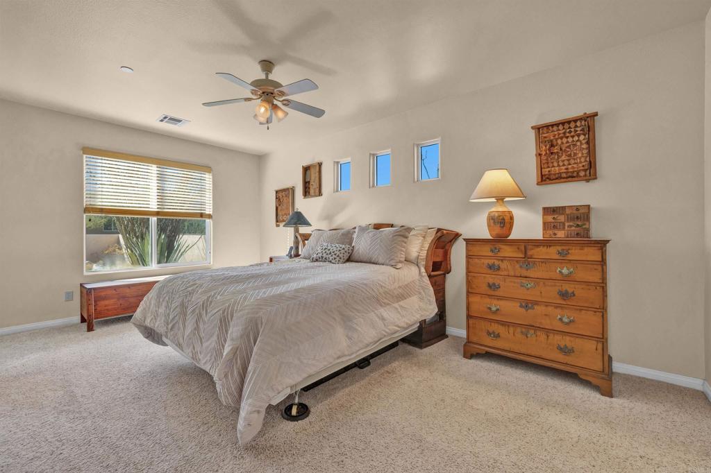 3486 Swinging V Road Borrego Springs, CA 92004 - Photo 14 of 41 a bedroom with a bed and a chandelier