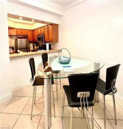 a dining room with furniture and a kitchen view