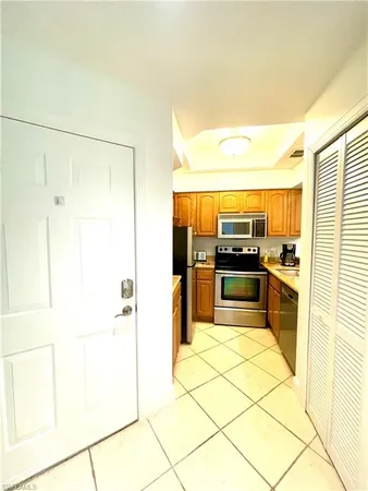 a large kitchen with cabinets and stainless steel appliances