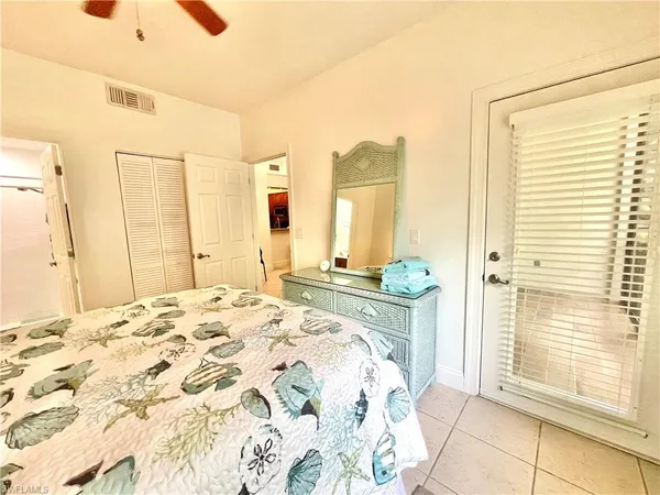 a spacious bedroom with a bed and a window