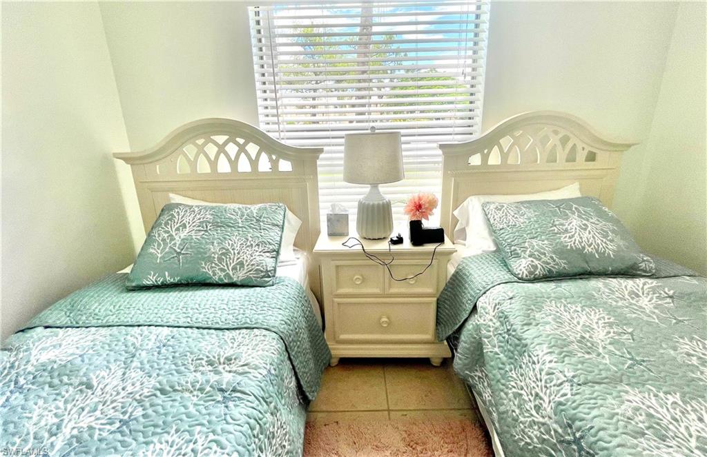 Undisclosed Address Naples, FL 34105 - Photo 7 of 15 a bed sitting in a bedroom next to a window