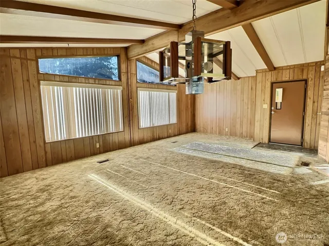 a view of a bedroom with wooden floor and furniture