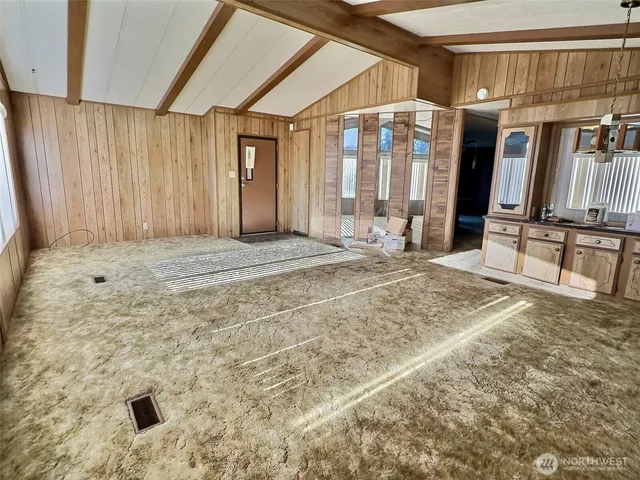 a kitchen with a table chairs and refrigerator