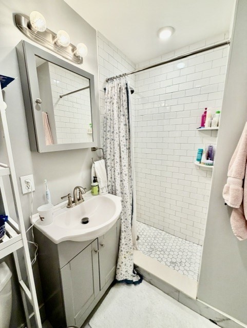 14 Cleveland Place, Unit 3 Boston, MA 02113 - Photo 12 of 22 a bathroom with a sink a toilet and shower