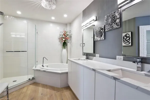 a bathroom with a sink a large mirror and a shower