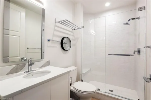 a bathroom with a sink toilet and shower