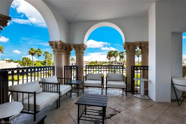 a view of a balcony with furniture
