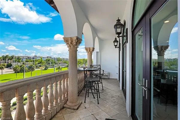 a view of a chairs and table in the balcony
