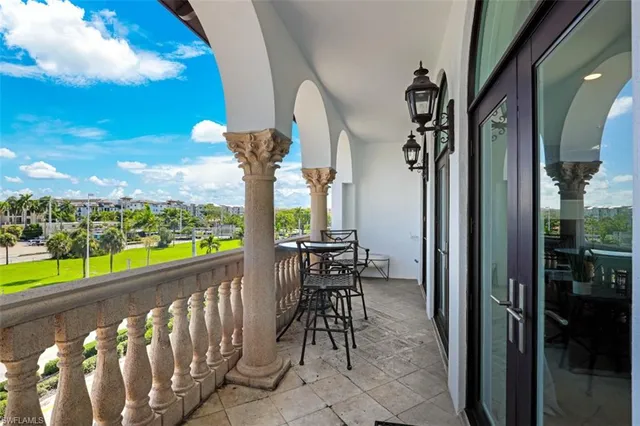 a view of a chairs and table in the balcony