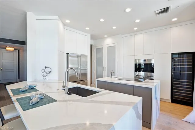 a large kitchen with kitchen island a stove a sink and a refrigerator