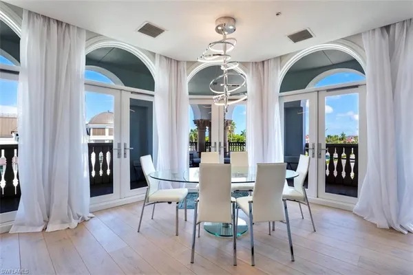 a view of a dining room with furniture wooden floor and chandelier