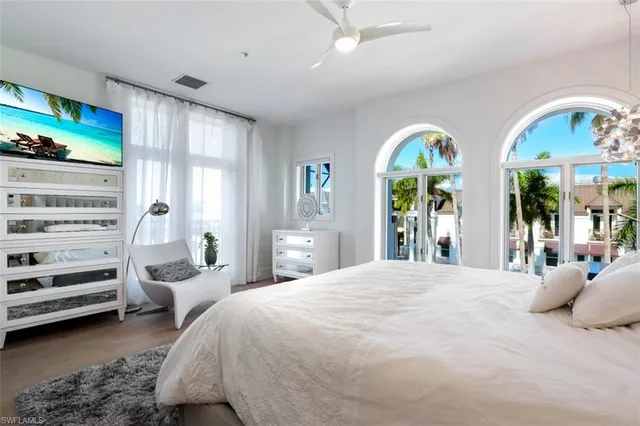 a bedroom with a bed and glass windows