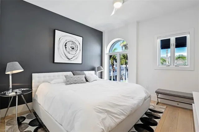 a bedroom with a bed and a lamp on table