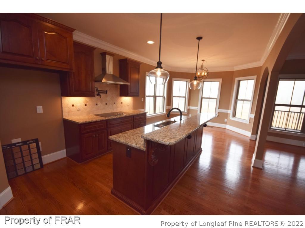 800 South River Road Stedman, NC 28391 - Photo 3 of 23 a kitchen with stainless steel appliances granite countertop a sink stove and wooden floor