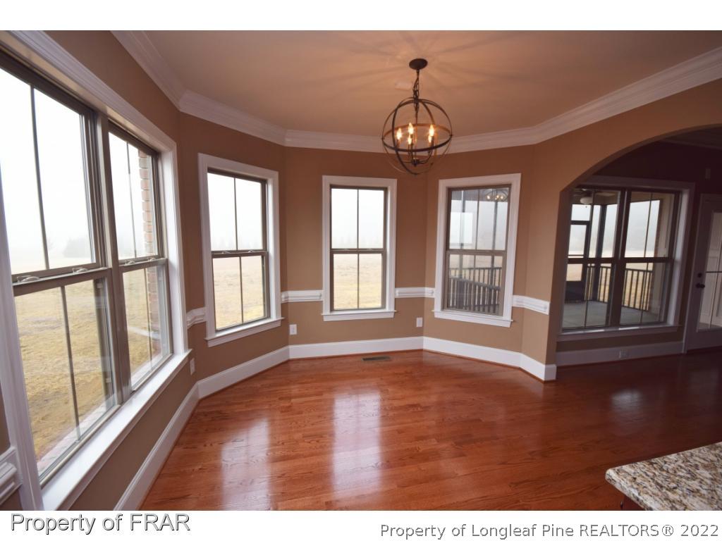 800 South River Road Stedman, NC 28391 - Photo 4 of 23 a view of an empty room with wooden floor and a window