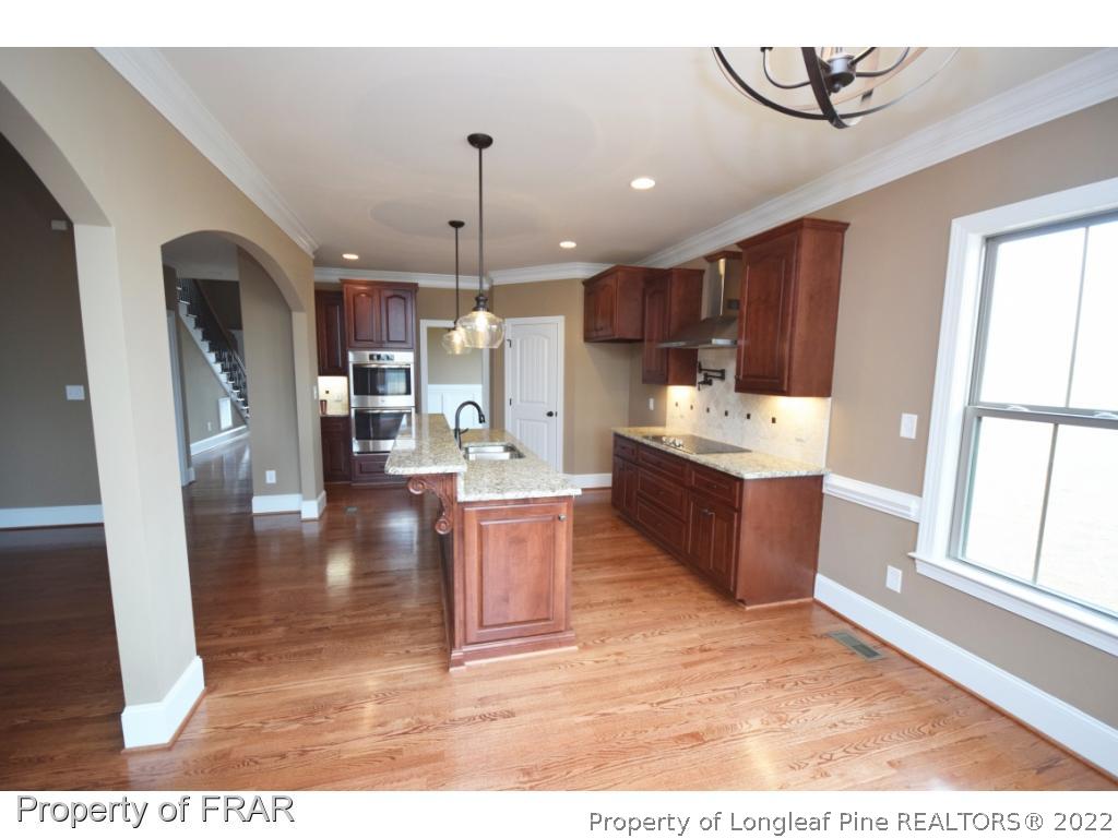 800 South River Road Stedman, NC 28391 - Photo 5 of 23 a large kitchen with a counter space a sink appliances and cabinets