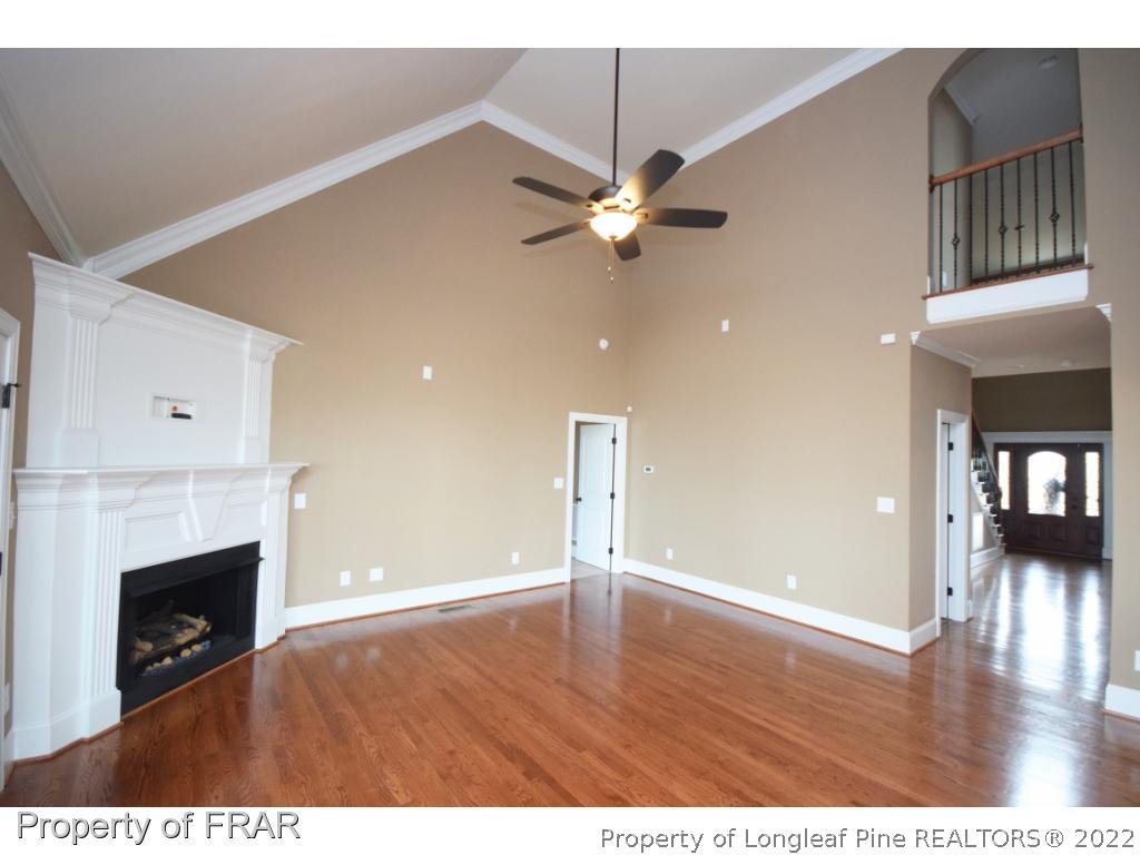 800 South River Road Stedman, NC 28391 - Photo 7 of 23 a view of an empty room with wooden floor and a fireplace