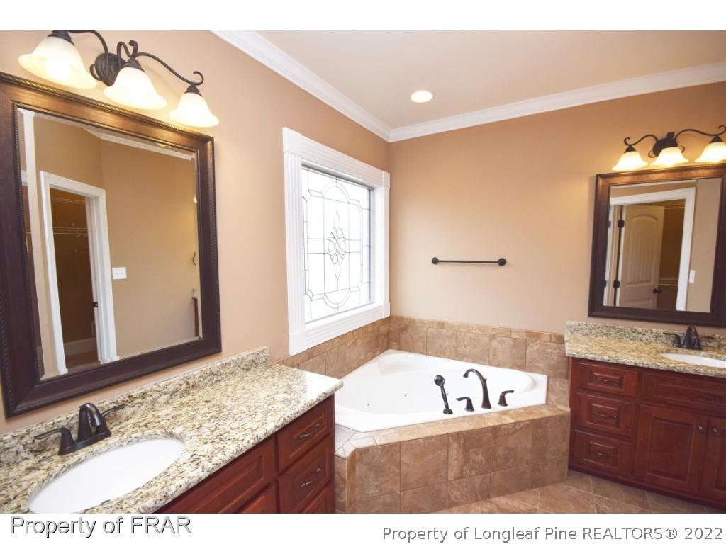 800 South River Road Stedman, NC 28391 - Photo 9 of 23 a bathroom with a granite countertop tub sink and mirror