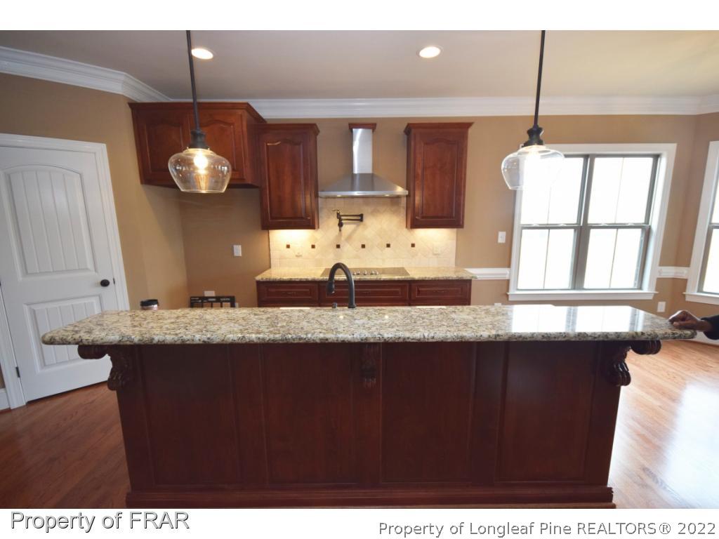 800 South River Road Stedman, NC 28391 - Photo 10 of 23 a kitchen with granite countertop a sink cabinets and wooden floor