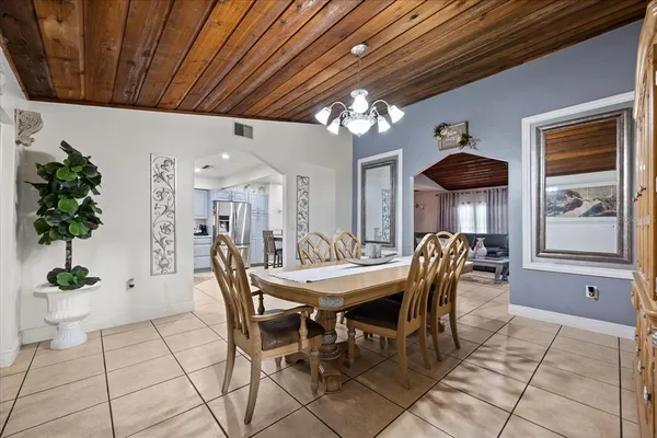 a view of a dining room with furniture and chandelier
