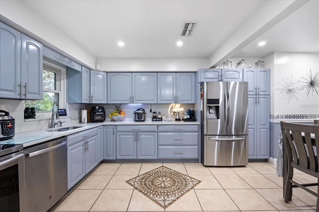2270 Old Hickory Tree Road St. Cloud, FL 34772 - Photo 20 of 40 a kitchen with granite countertop a refrigerator and a stove top oven