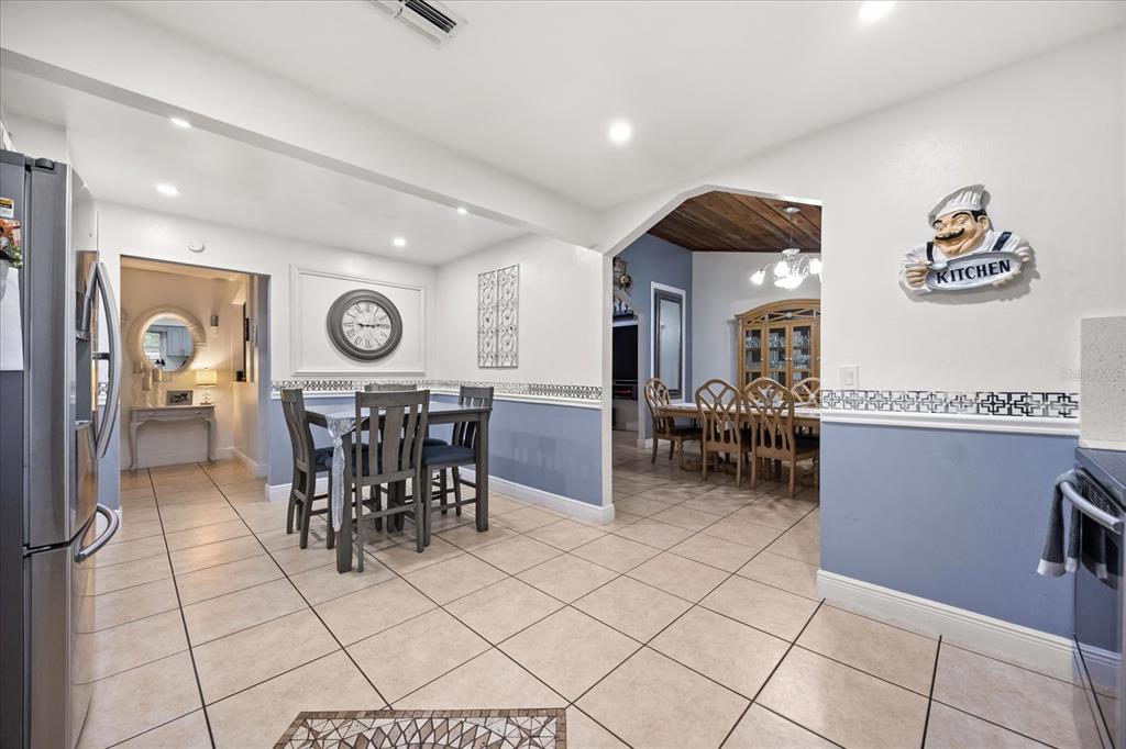 2270 Old Hickory Tree Road St. Cloud, FL 34772 - Photo 22 of 40 a view of a dining area with furniture and a large window