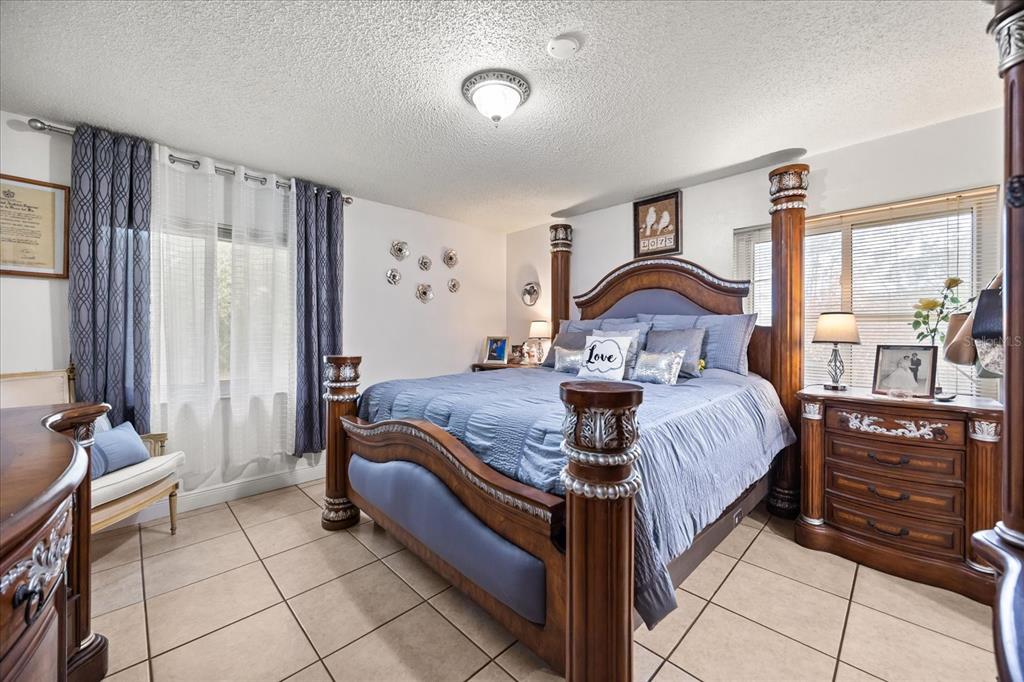 2270 Old Hickory Tree Road St. Cloud, FL 34772 - Photo 23 of 40 a bedroom with a bed and wooden floor