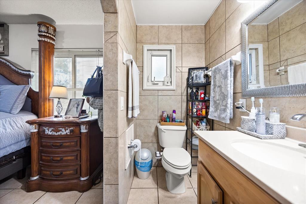 2270 Old Hickory Tree Road St. Cloud, FL 34772 - Photo 26 of 40 a bathroom with a toilet a sink and a mirror
