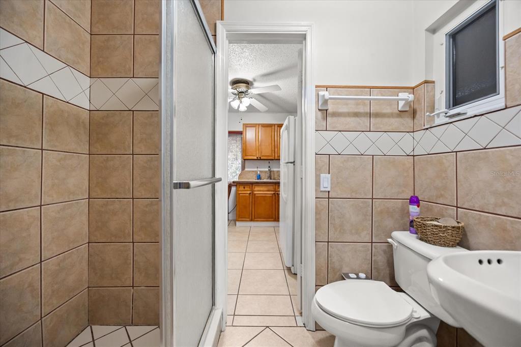 2270 Old Hickory Tree Road St. Cloud, FL 34772 - Photo 28 of 40 a white toilet sitting next to a bathroom sink