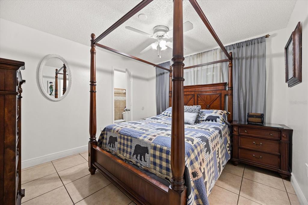 2270 Old Hickory Tree Road St. Cloud, FL 34772 - Photo 29 of 40 a bedroom with a bed window and a mirror