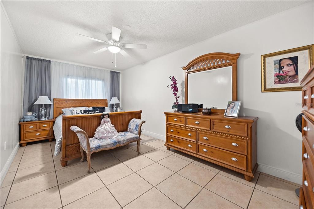 2270 Old Hickory Tree Road St. Cloud, FL 34772 - Photo 31 of 40 a bedroom with a bed and a chandelier