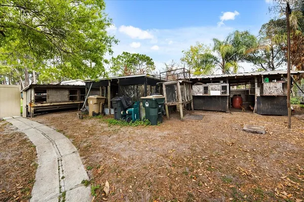 a view of a backyard with furniture and trees
